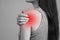 A spasm on the girl`s shoulder. Shoulder and joint injuries, and fatigue at work. The zone of injury, the image on a blank