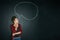 Speak your mind. Studio shot of a young woman posing with a chalk illustration of a speech bubble against a dark