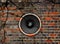 Speaker on a cracked brick wall background