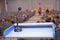 Speaker prepare before speaking to the audience behind the podium focused microphone on the podium and blurred empty seat and some