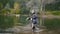 Spear fisherman shows Freshwater Fish at after hunting in forest river