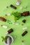 Spearmint herb and mortar and pestle on green background