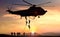 Special force assault team helicopter drops during sunset