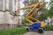 Special machine for lifting to a height. A worker makes restoration of an old building of the Evangelical Church at a high