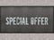 SPECIAL OFFER painted on metal panel wall.