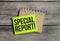 SPECIAL REPORT word on green sticker and wooden background