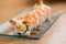 Special rice roll with shrimp tempura, avocado, salad, red onion,.cooked salmon, caviar, sliced onion and Teriyaki sauce