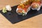 Special roll of rice with salmon, avocado, different types of caviar