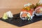 Special roll of rice with salmon, avocado, different types of caviar