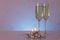 Special tinted photo of greeting card template made of two glasses of champagne with two candles, christmas balls and string of b