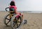 Special wheelchair with big wheels and a little girl in summer