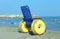 Special wheelchair with large yellow inflatable wheels to bring