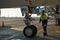 A specialist aircraft mechanic conducts preparatory work before takeoff of an air passenger ship at the parking lot