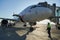 A specialist aircraft mechanic conducts preparatory work before takeoff of an air passenger ship at the parking lot