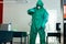 Specialist in chemical suit eliminating bacteria in the room stock photo