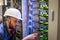 A specialist connects the wires in the server room of the data center. A man works with telecommunications. The technician