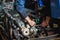 Specialist in coveralls working with motorized bicycles at repair garage. Hands in the frame. Close-up. Motorcycle repair.