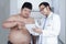 Specialist doctor with overweight patient