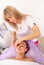 Specialist gives the girl massage and spa treatments for beauty and rejuvenation in the office