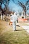 Specialist man in hazmat suits cleaning garden and park, disinfecting and decontaminating surfaces