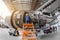 Specialist mechanic repairs the maintenance of a large engine of a passenger aircraft in a hangar.