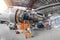 Specialist mechanic repairs the maintenance of a large engine of a passenger aircraft in a hangar.