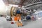 Specialist mechanic repairs the maintenance of a large engine of a passenger aircraft in a hangar. View of engine without bonnet,