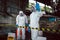 Specialist Officers in Chemical Safety Wear Chemical Risk Protective Clothing Hand Raised Saying Caution for Chemical Spill while