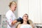 Specialist pierces the client& x27;s ears with a piercing gun. Caucasian woman having ear piercing process. Beauty procedure