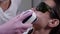 Specialist in a pink gloves does laser depilation of moustaches.