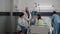 Specialist practitioner doctors monitoring sick man explaining illness treatment