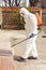 Specialist in a protective suit with a disinfection sprayer