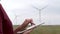 A specialist uses a tablet to operate wind farms. Production of environmentally friendly electricity.