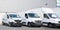 Specialized delivery society parking with several white small trucks van