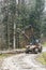 A specialized forest tractor working with logging in the rain in the Carpathians, Poland