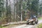 A specialized forest tractor working with logging in the rain in the Carpathians, Poland