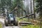 A specialized forest tractor working with logging in the rain in the Carpathians, Poland