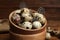 Speckled quail eggs and feathers, closeup view