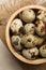 Speckled quail eggs on white table, top view