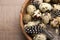 Speckled quail eggs on wooden table, closeup.