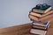 Spectacles and pencil on book stack