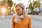 Spectacular blonde girl in knitted sweater posing in park early in evening. Close-up outdoor portrait of tired european