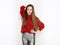 Spectacular blonde woman in red blouse silver leather pants posing in front of white wall. Graceful girl gorgeous long hair having