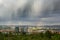 Spectacular clouds and rainbow over city