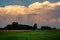 Spectacular colorful clouds over the forest and meadow