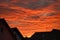 Spectacular colors of sunset over the roofs of a city