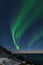 Spectacular dancing green strong northern lights over the famous round boulder beach near Uttakleiv on the Lofoten islands in