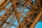 Spectacular detail of the Eiffel tower metal structure with a blue sky.