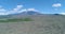 Spectacular drone aerial reveal of active volcano Etna in the beautiful island of Sicily. Clouds cover the top of