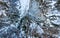 Spectacular drop down view of waterfall falling over rocky forest ledge.